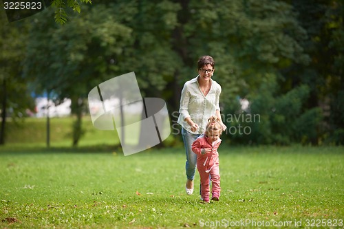 Image of happy family playing together outdoor in park