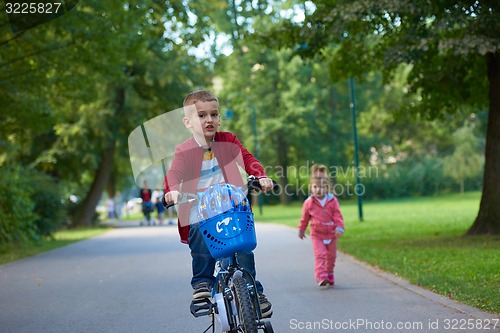 Image of boy and girl with bicycle