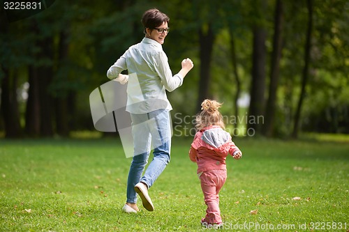 Image of happy family playing together outdoor in park