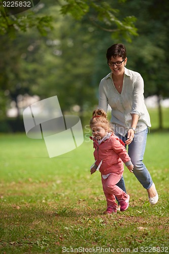 Image of happy family playing together outdoor in park