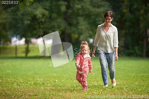 Image of happy family playing together outdoor in park