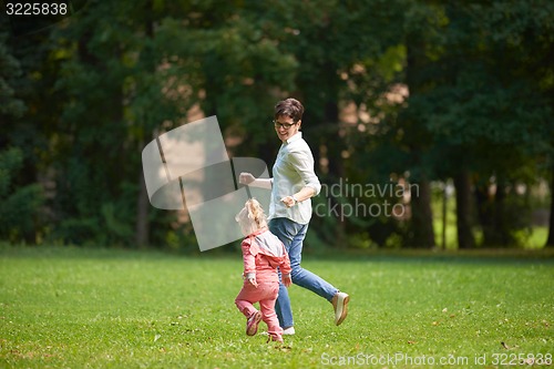 Image of happy family playing together outdoor in park