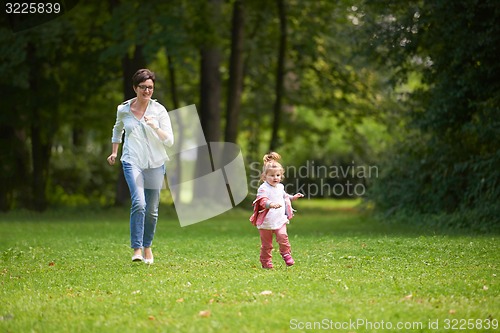 Image of happy family playing together outdoor in park