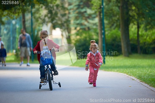 Image of boy and girl with bicycle