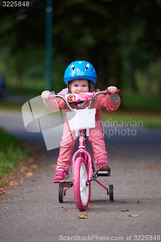 Image of little girl with bicycle