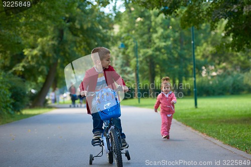 Image of boy and girl with bicycle