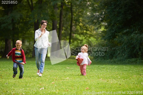 Image of happy family playing together outdoor in park