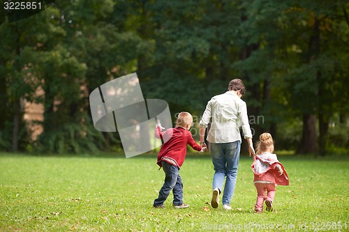 Image of happy family playing together outdoor in park