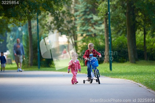 Image of boy and girl with bicycle