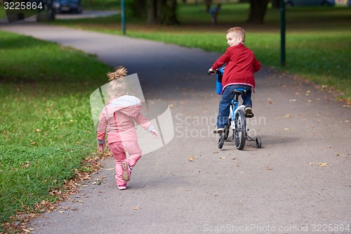 Image of boy and girl with bicycle