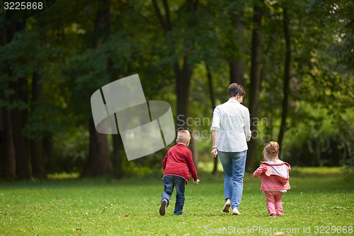 Image of happy family playing together outdoor in park