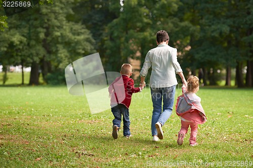 Image of happy family playing together outdoor in park