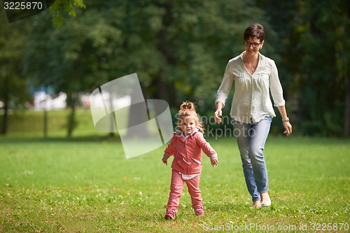 Image of happy family playing together outdoor in park