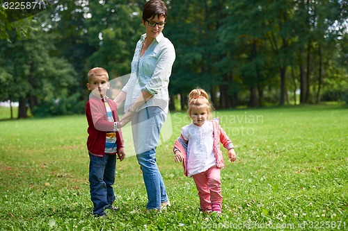 Image of happy family playing together outdoor in park