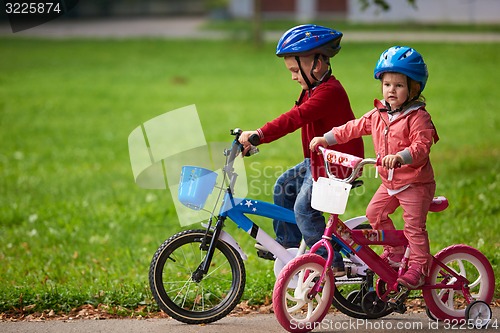 Image of boy and girl with bicycle