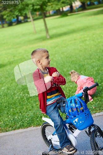 Image of boy and girl with bicycle