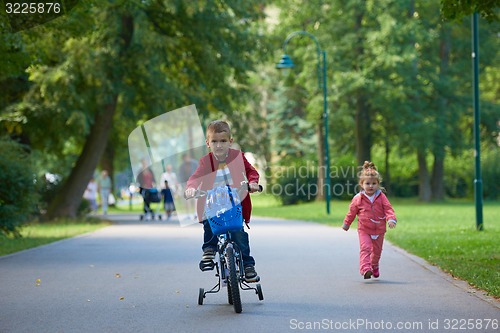 Image of boy and girl with bicycle