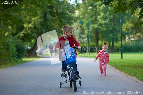 Image of boy and girl with bicycle