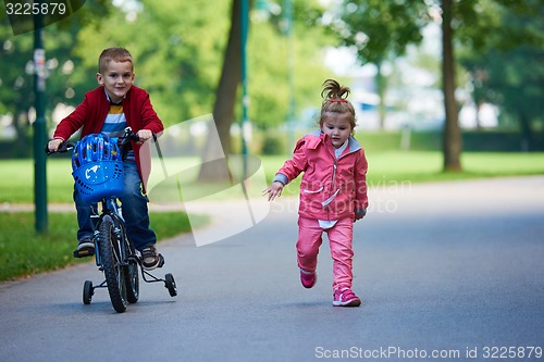 Image of boy and girl with bicycle