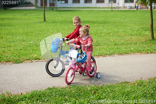 Image of boy and girl with bicycle