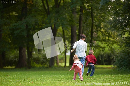 Image of happy family playing together outdoor in park