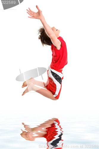 Image of Leaping child hands stretched to sky