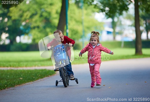 Image of boy and girl with bicycle