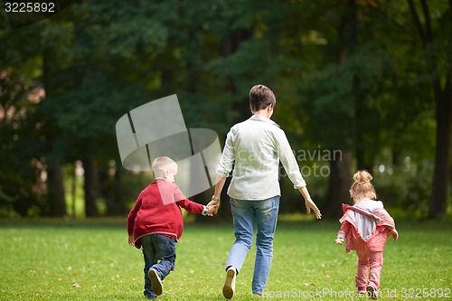 Image of happy family playing together outdoor in park