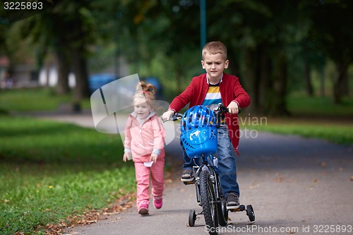 Image of boy and girl with bicycle