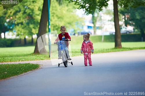 Image of boy and girl with bicycle