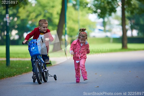 Image of boy and girl with bicycle