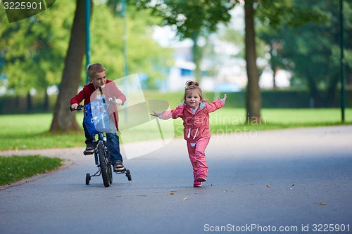 Image of boy and girl with bicycle