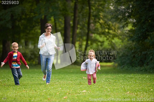 Image of happy family playing together outdoor in park
