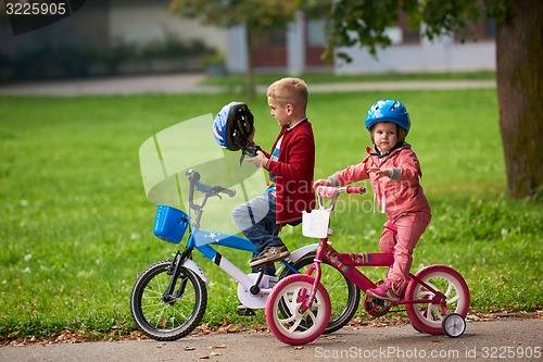 Image of boy and girl with bicycle