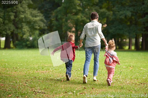 Image of happy family playing together outdoor in park