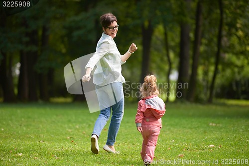Image of happy family playing together outdoor in park