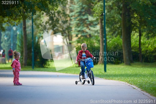 Image of boy and girl with bicycle