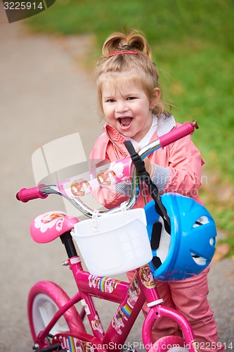 Image of little girl with bicycle