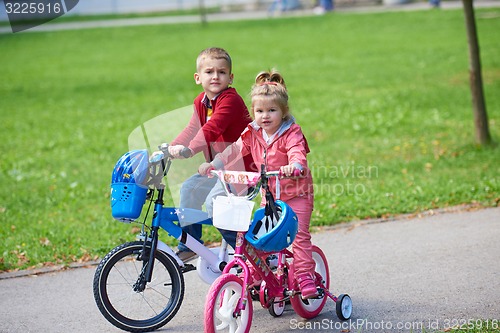 Image of boy and girl with bicycle