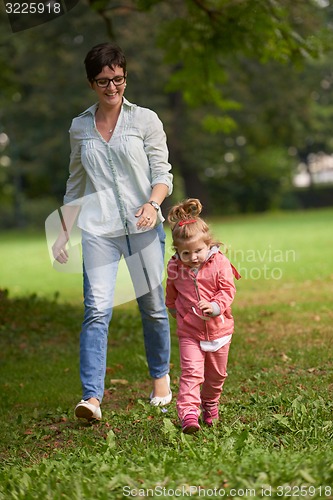 Image of happy family playing together outdoor in park