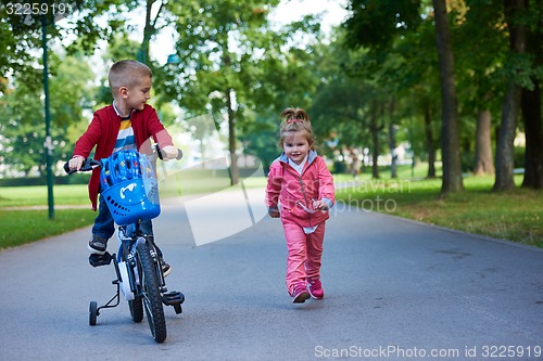 Image of boy and girl with bicycle