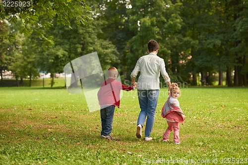 Image of happy family playing together outdoor in park