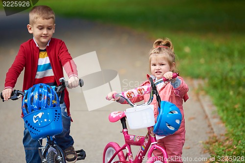 Image of boy and girl with bicycle