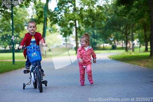 Image of boy and girl with bicycle