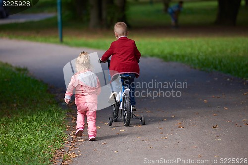 Image of boy and girl with bicycle