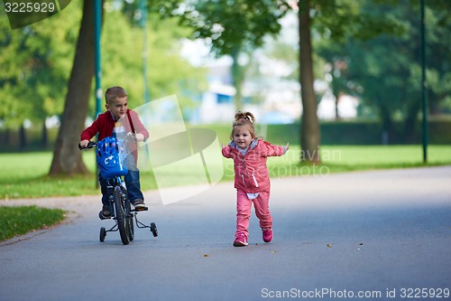 Image of boy and girl with bicycle