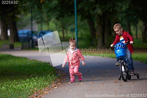 Image of boy and girl with bicycle