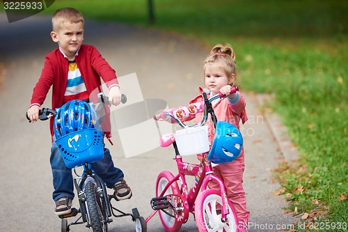 Image of boy and girl with bicycle