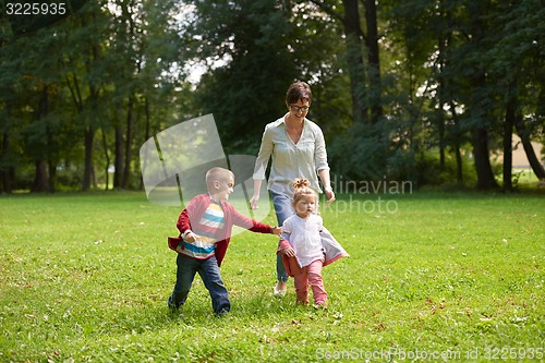 Image of happy family playing together outdoor in park