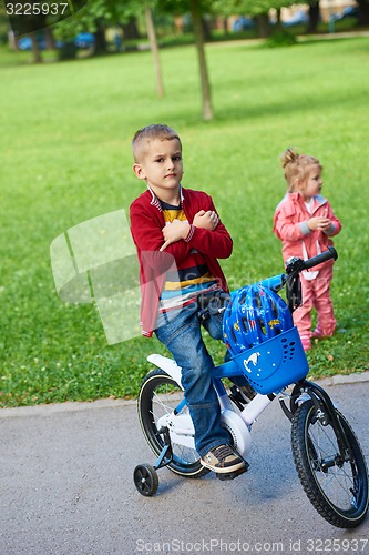 Image of boy and girl with bicycle